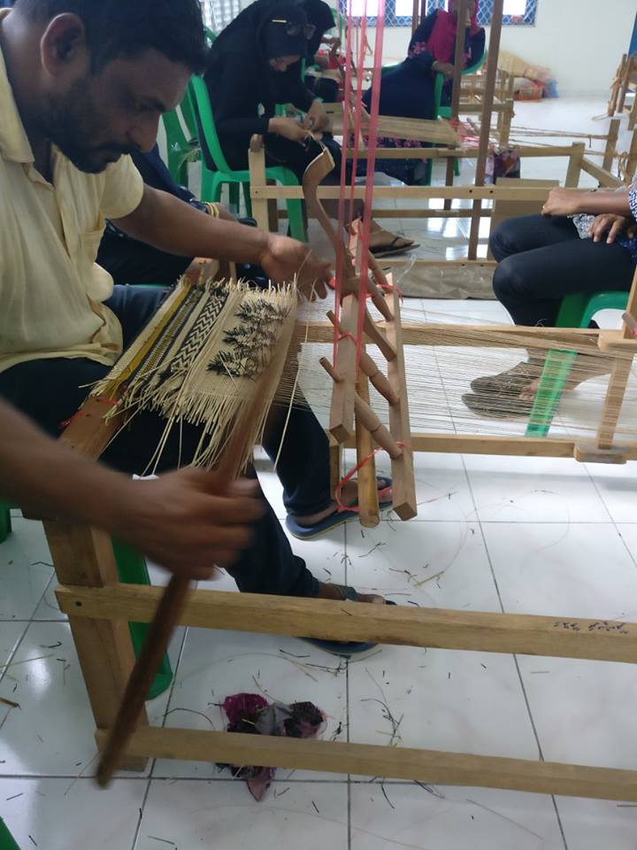 A-group-of-maldivain-locals-sewing-traditional-mats