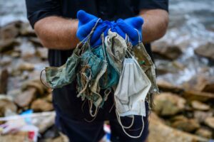 Gary Stokes of OceansAsia held masks found on a beach near Hong Kong in May. 