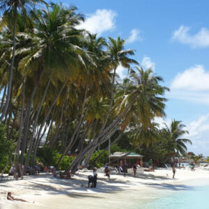 People enjoy the beach on Maafushi