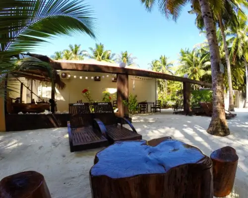 Deck chairs in front of a beach bar.