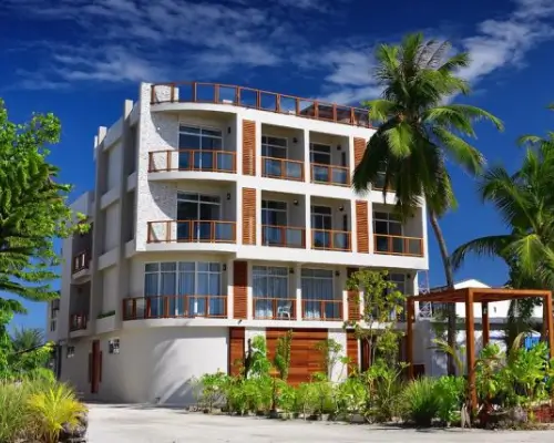 A 4 storey white and wooden guesthouse